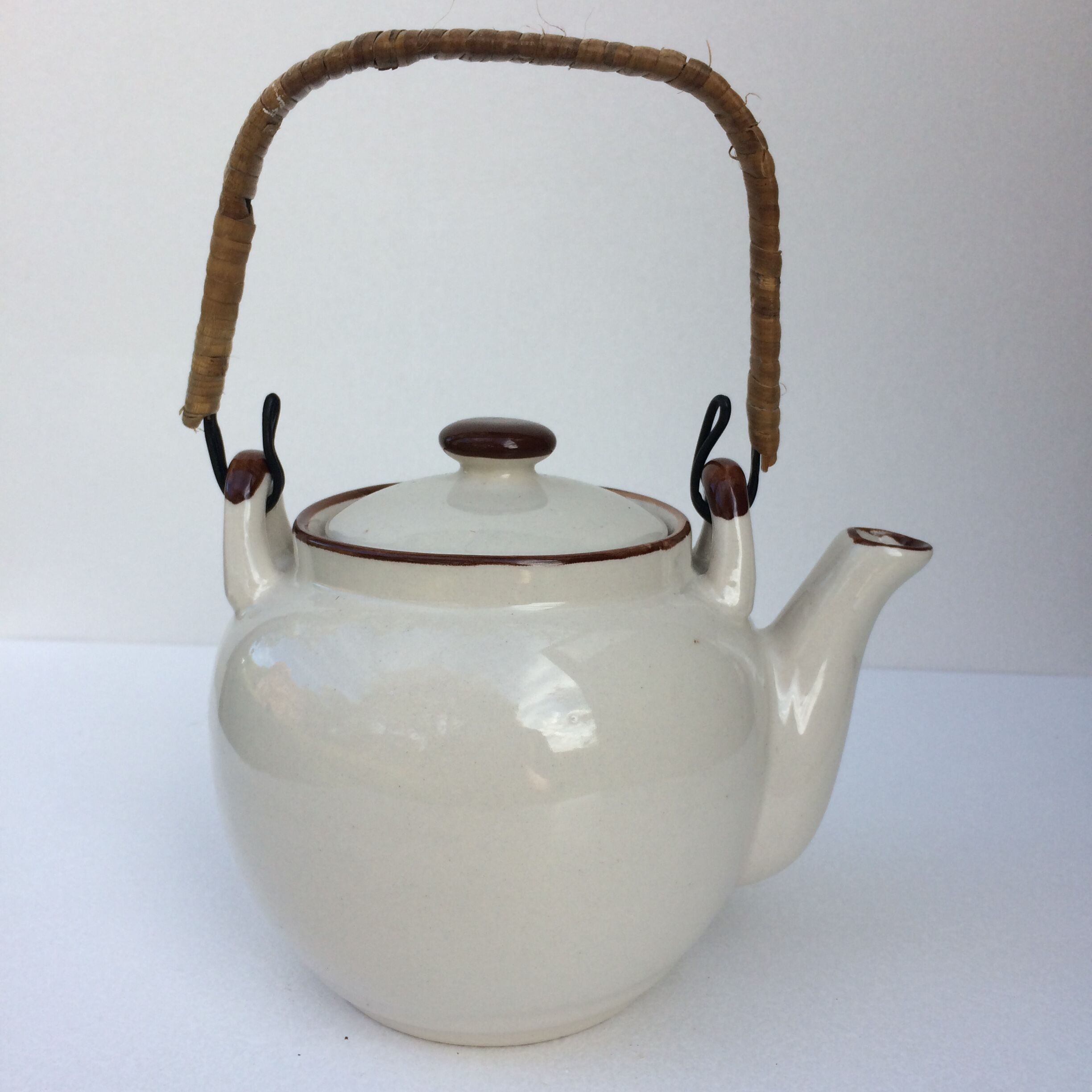 Vintage teapot with wicker handle