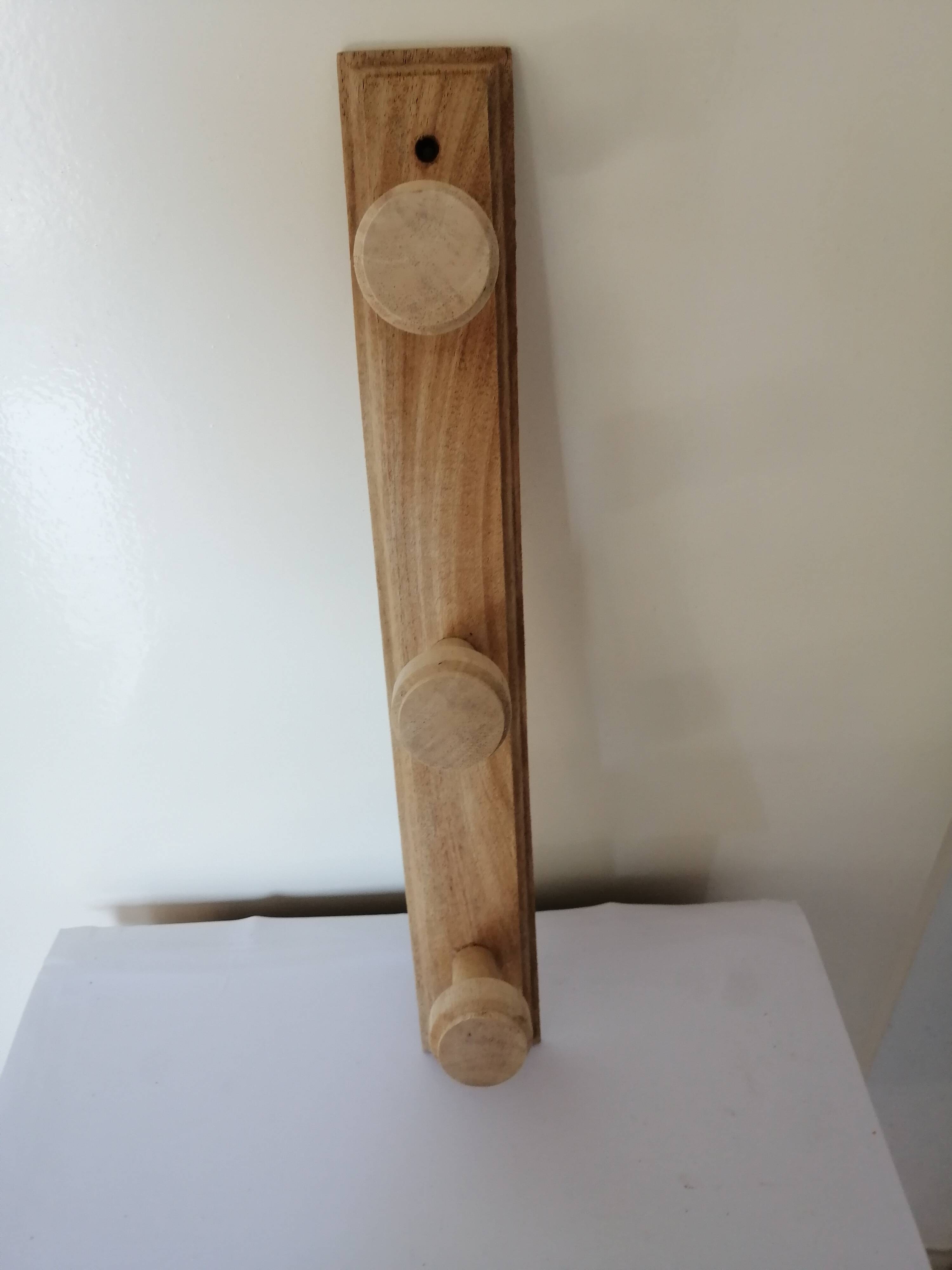 Old wall coat rack in raw wood