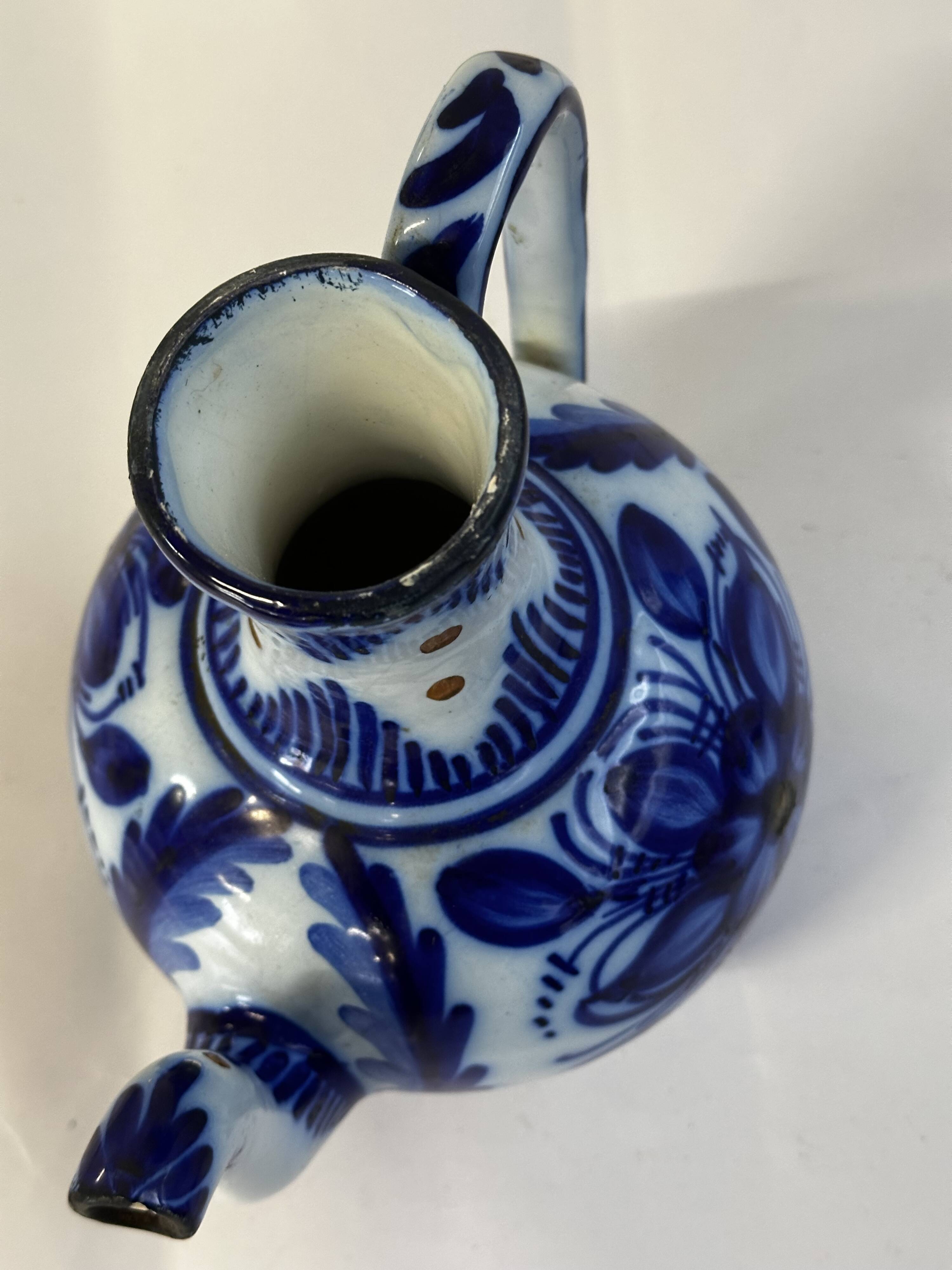 Glazed ceramic carafe with floral decoration