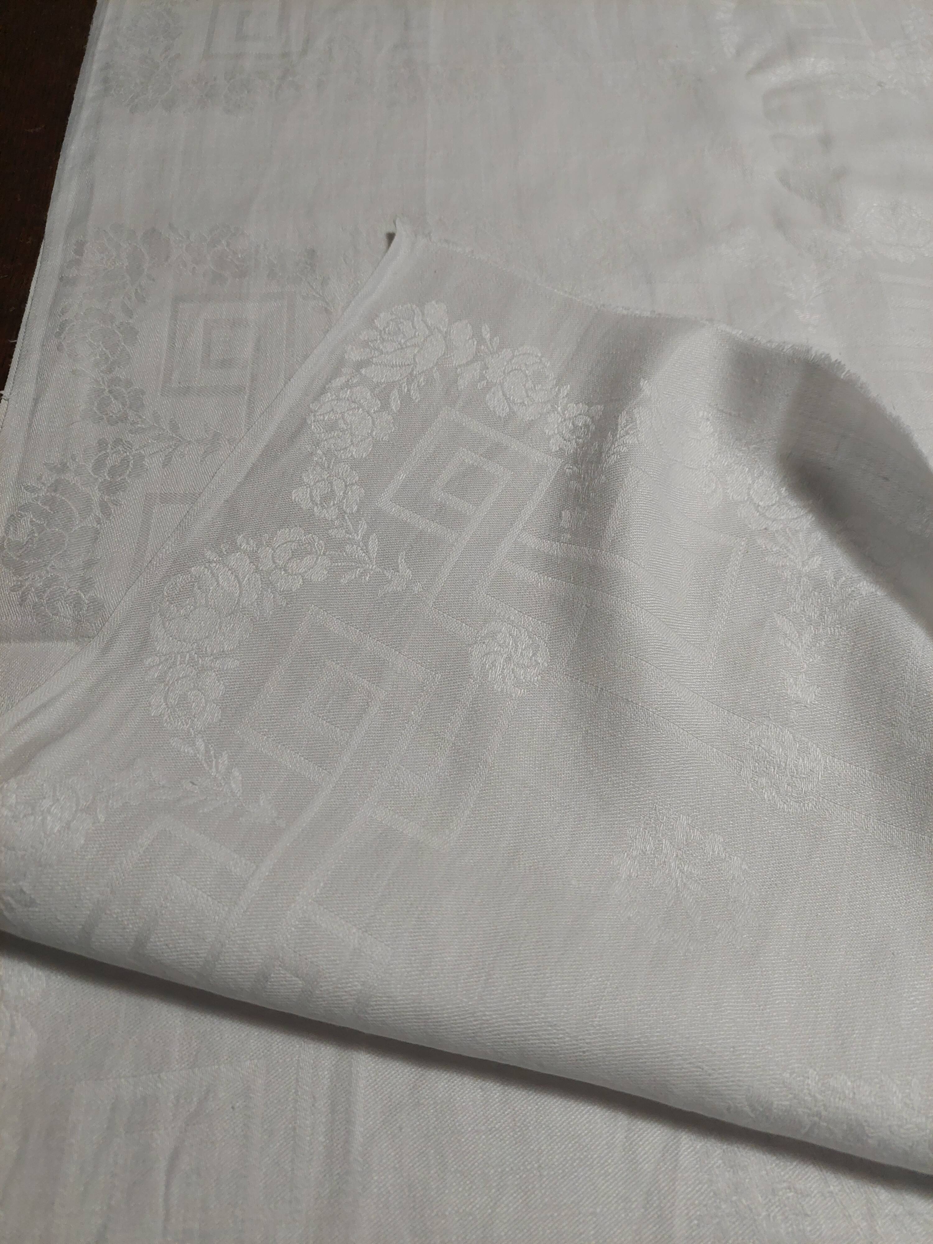 Table napkins set of eleven in a single piece damask linen and silk early 20th century.