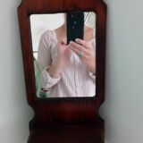Wooden wall mirror with its shelf