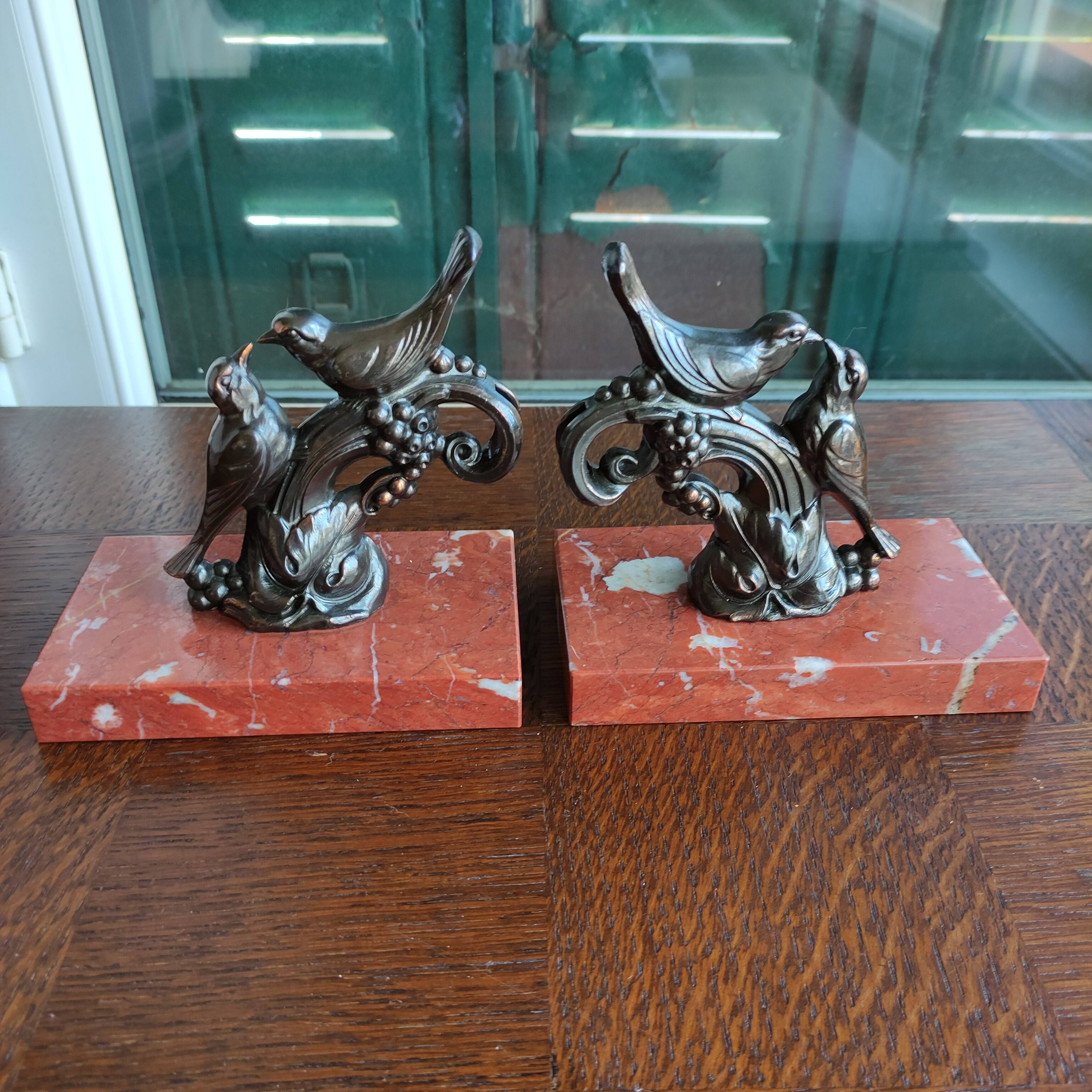 Zinc art bookends in the shape of birds on red marble - warblers