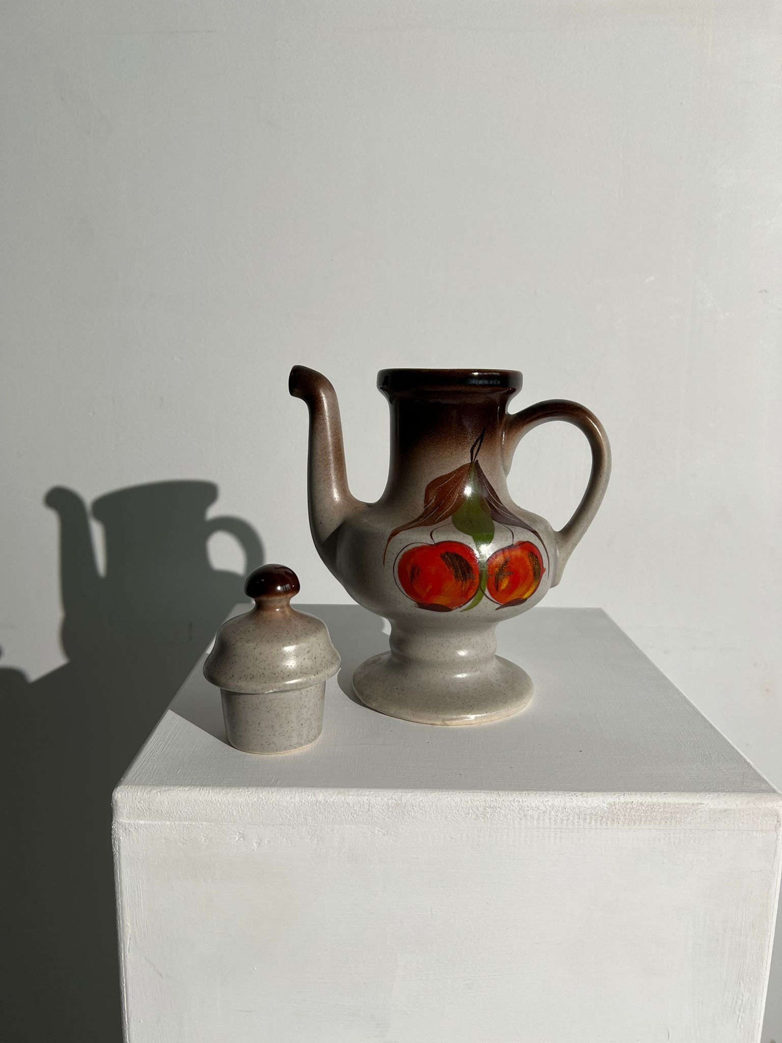 Vintage stoneware teapot with flower and fruit patterns