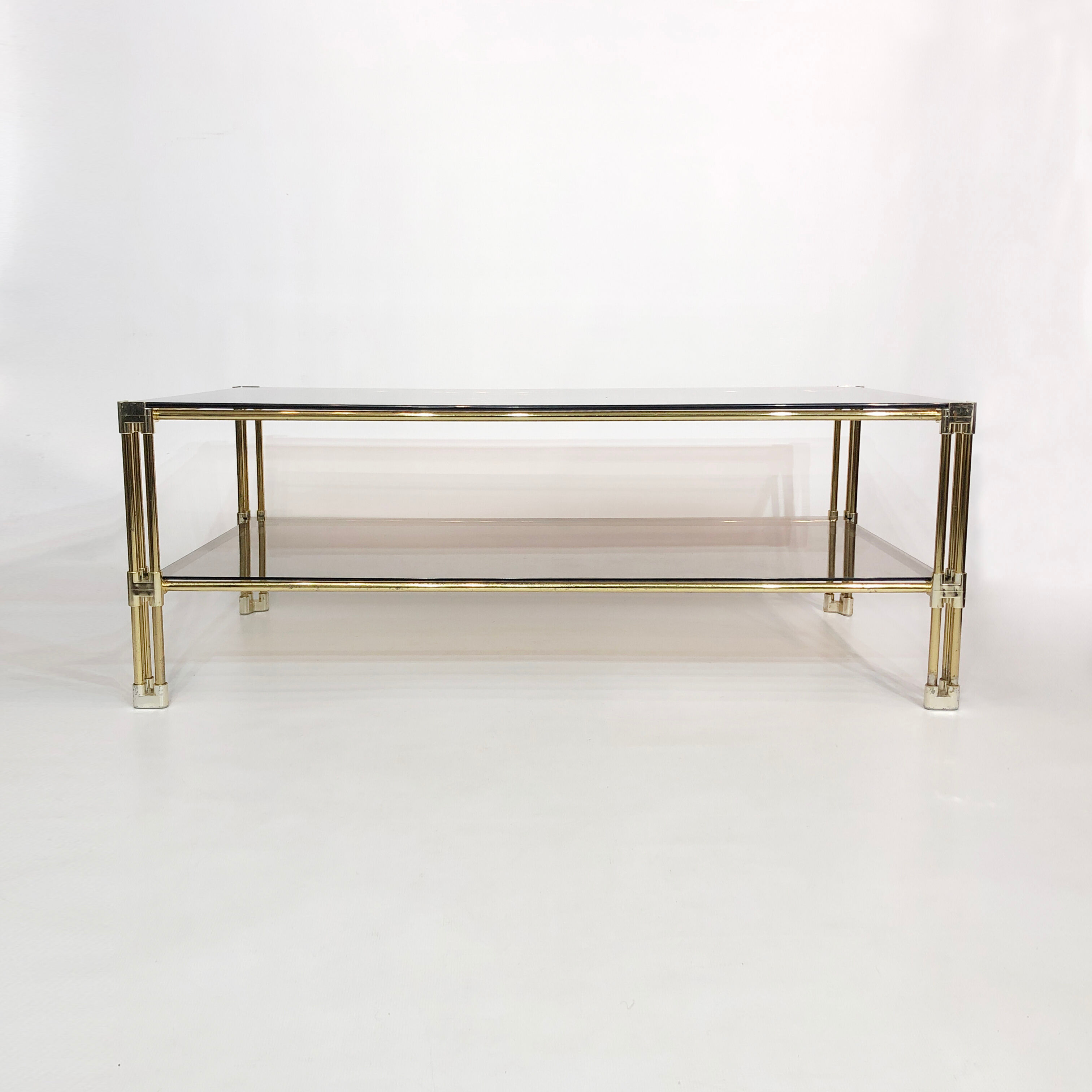 Brass two-tiered coffee table hollywood regency gold smoked glass 1970s