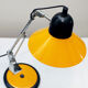 Aluminor desk lamp,vintage 70s, in orange-yellow and black lacquered metal. Good condition.