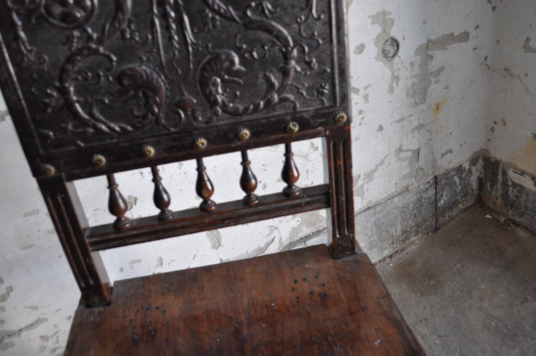 Pair of antique wooden and brown leather dining chairs, brass studs.