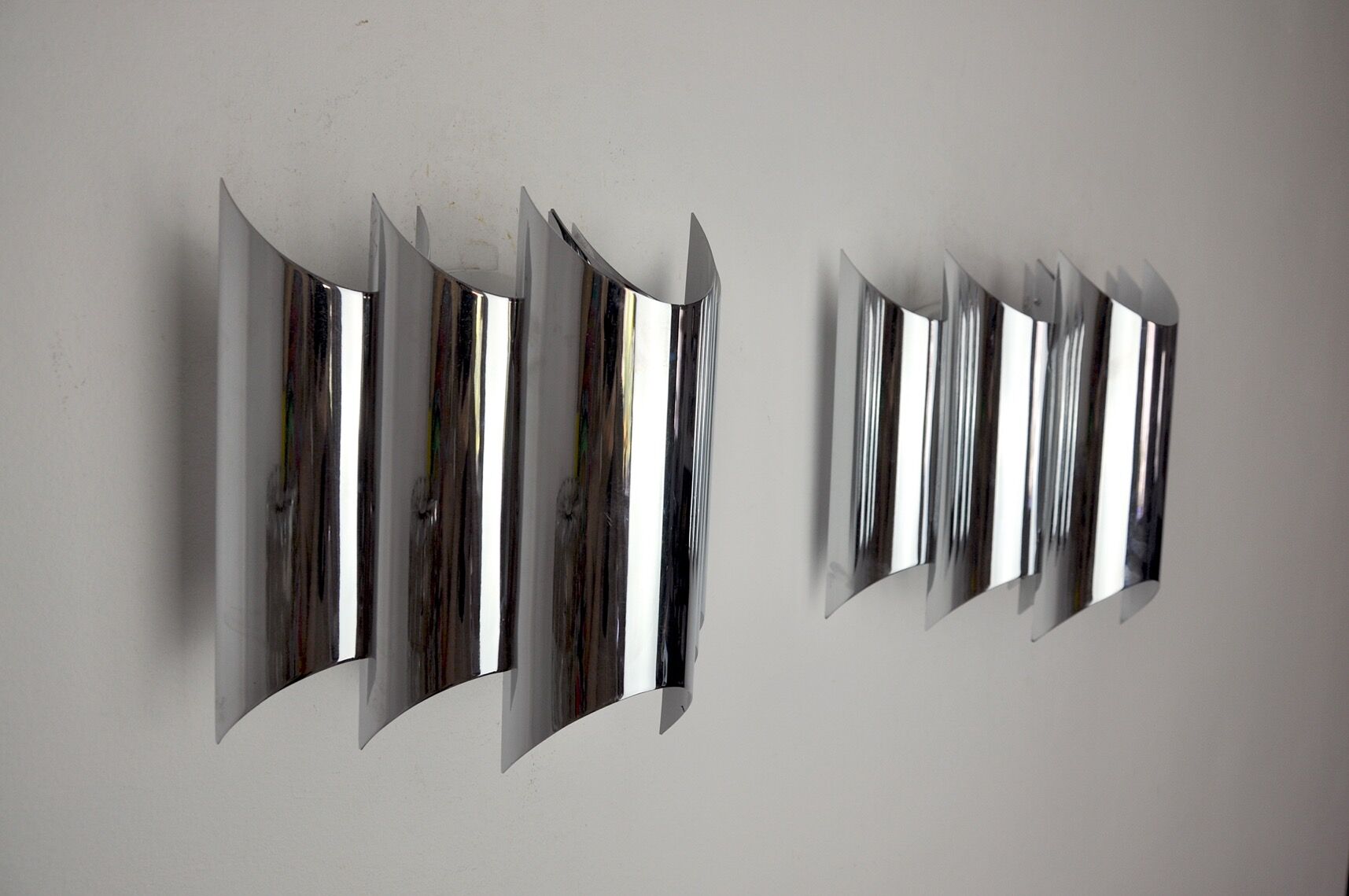 Pair of Raak wall lamps, space-age chrome design, Germany, 1970