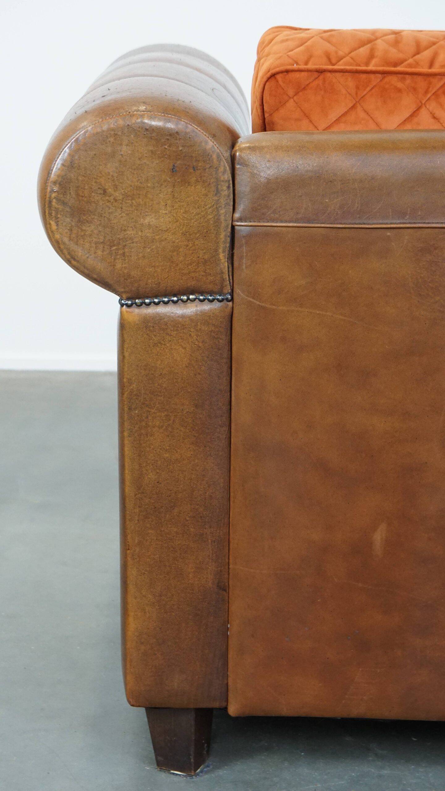 Luxury and comfortable sheepskin 2.5-seater sofa of top quality with orange fabric seat and back cushions