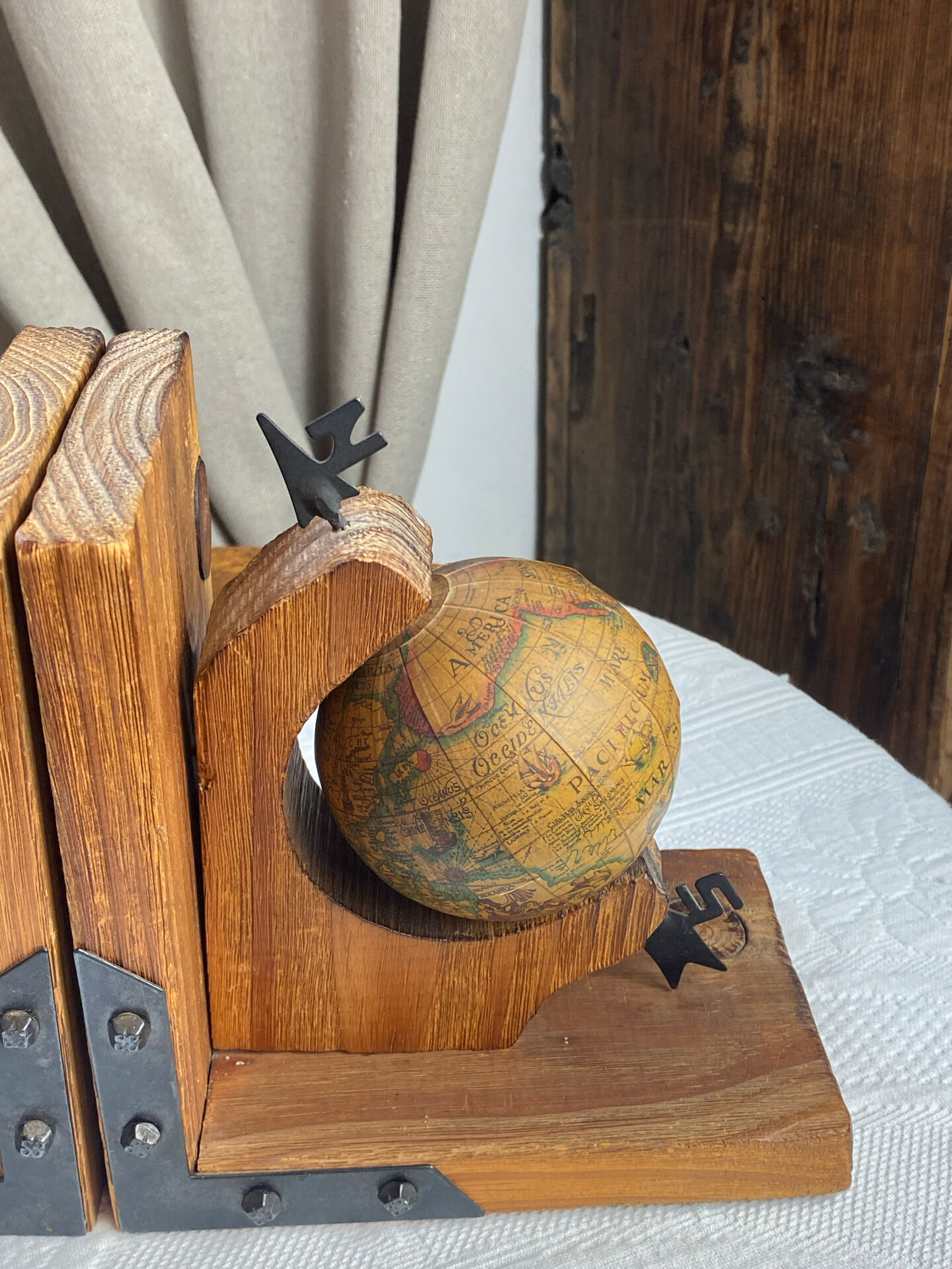 Pair of wooden bookends, rotating globes