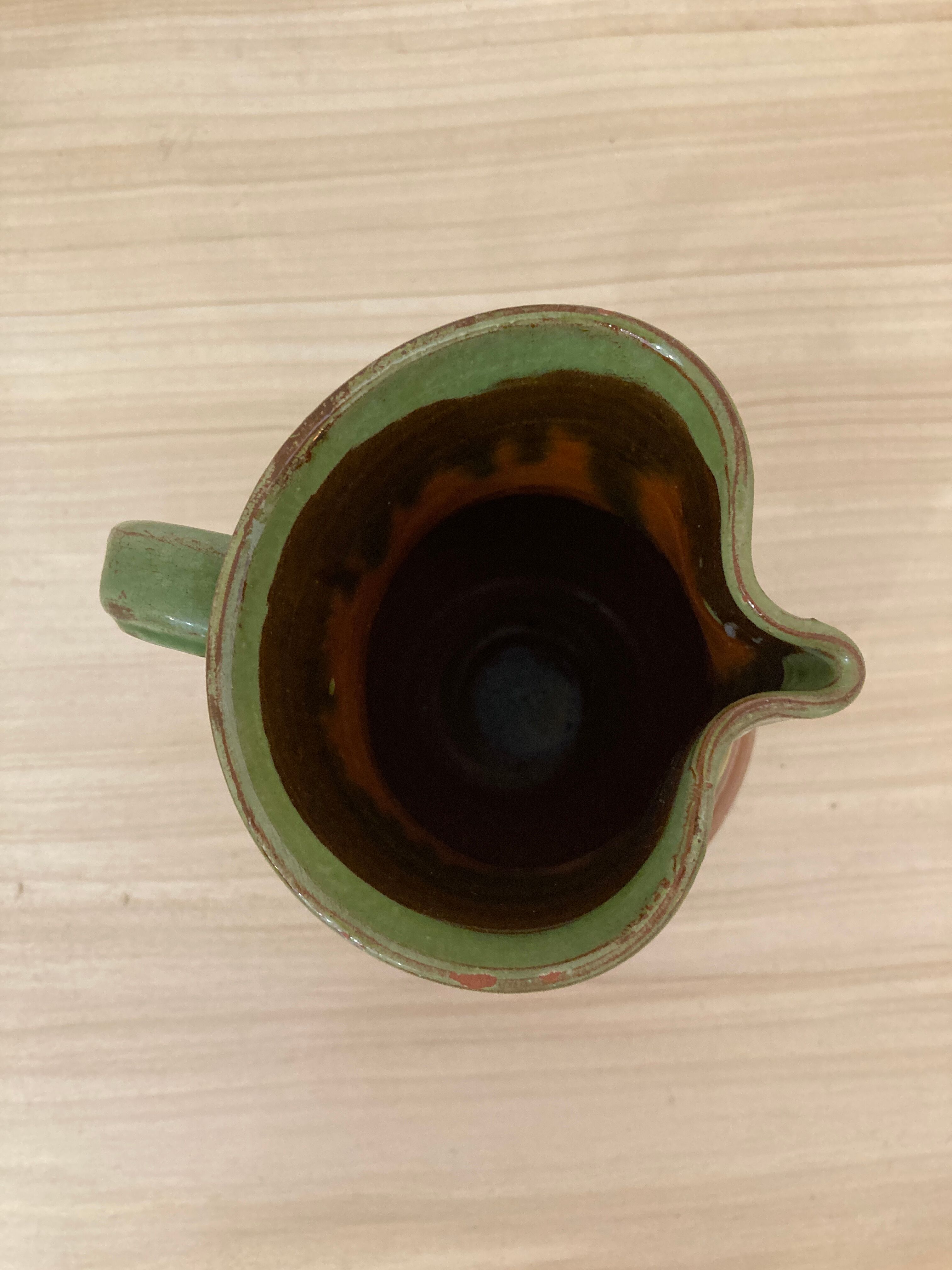 Green and brown ceramic pitcher