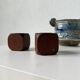 Pair of 1960s teak and brass "dice" candlesticks