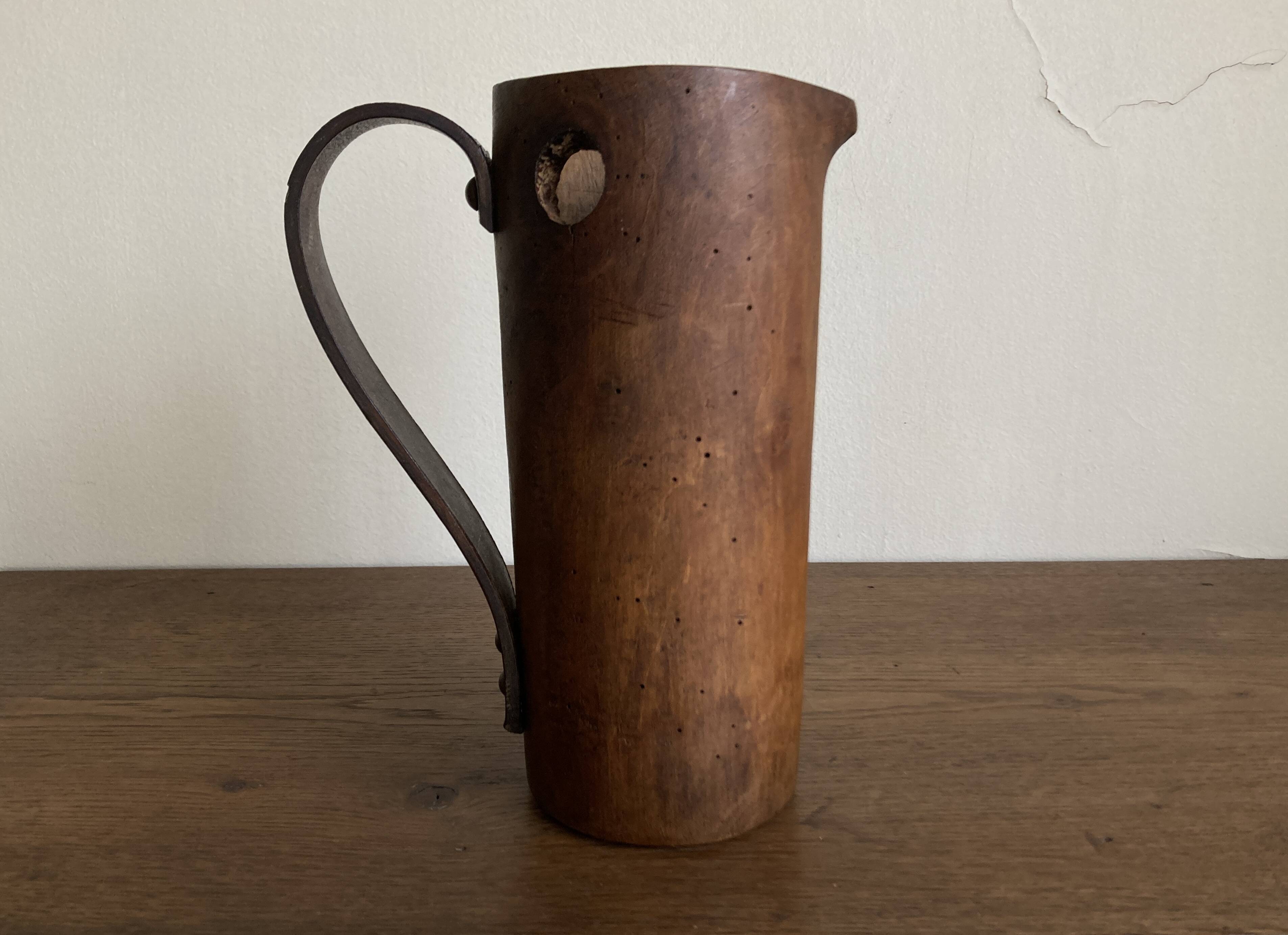 Mountain pitcher in monoxile wood and leather folk art