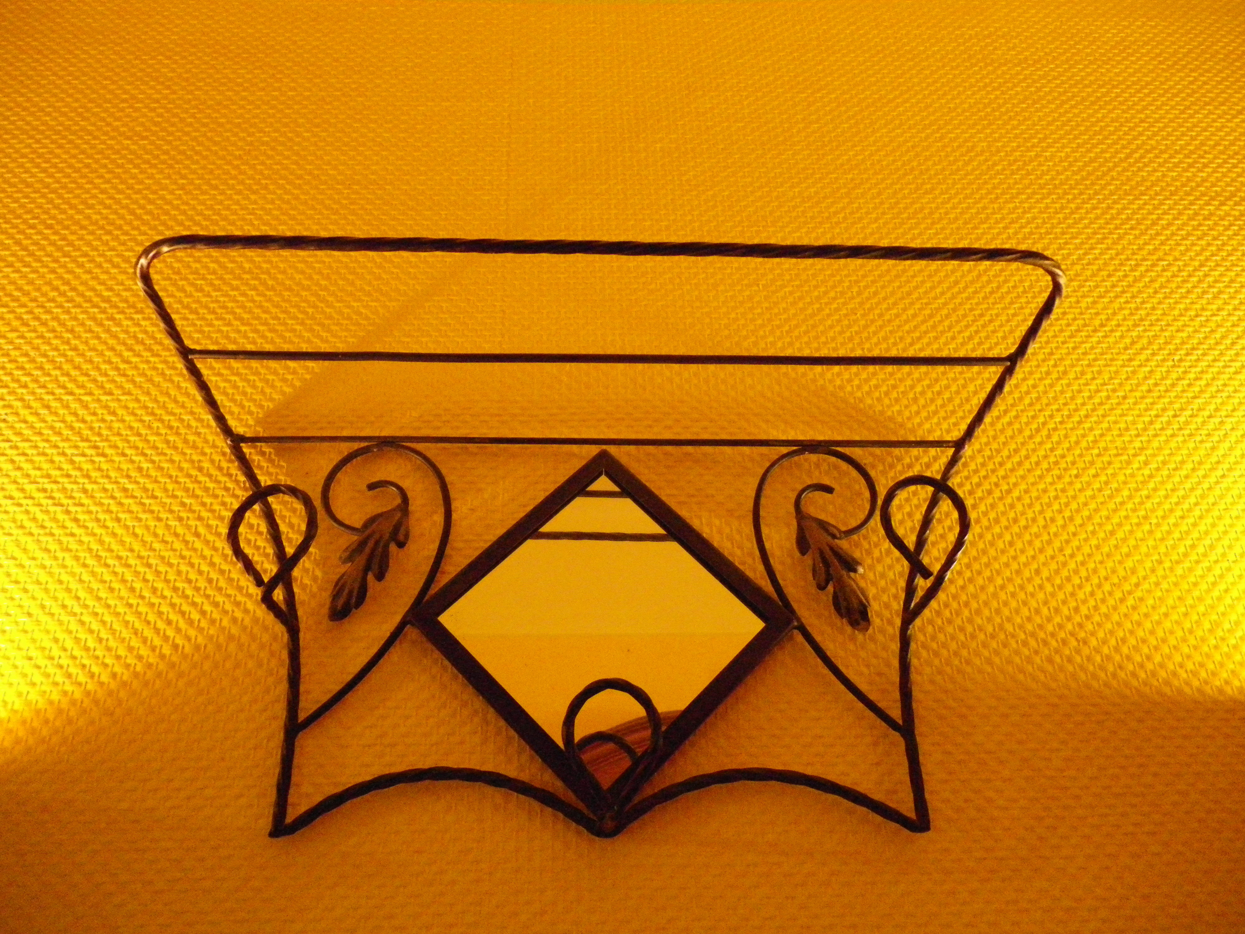Wrought iron wall holder with top support and built-in mirror