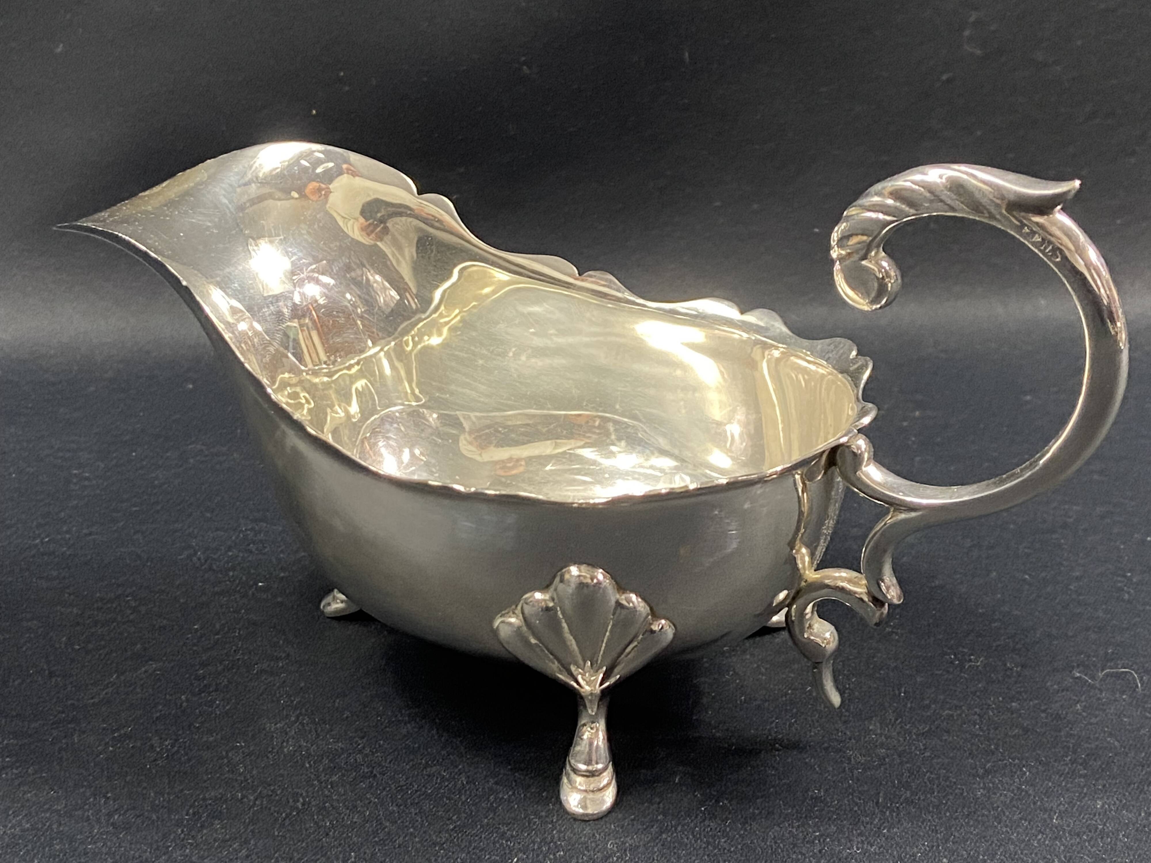 English George III style silver plated tripod sauce boat