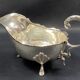 English George III style silver plated tripod sauce boat