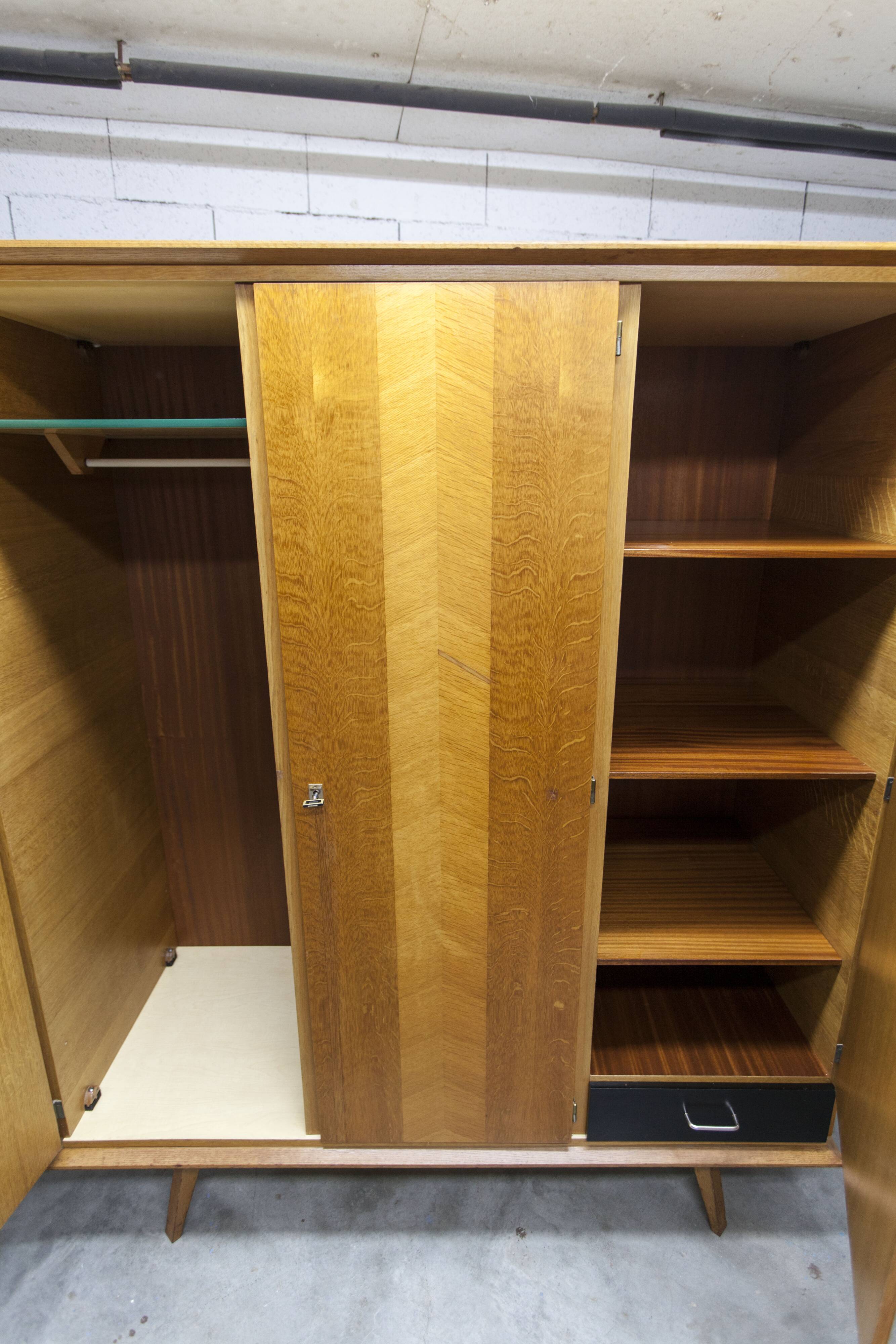 French wardrobe with tapered legs, 3 doors, 1 mirror (27*130), and 1 drawer.