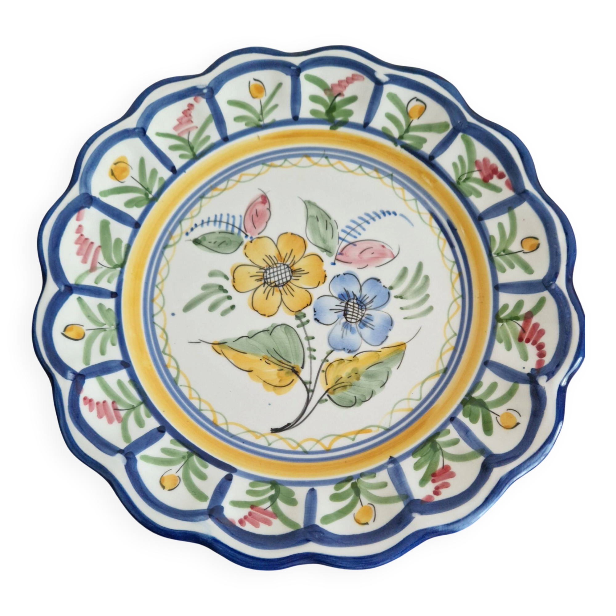 Large hand-painted French faience plate with floral decoration in folk art style.