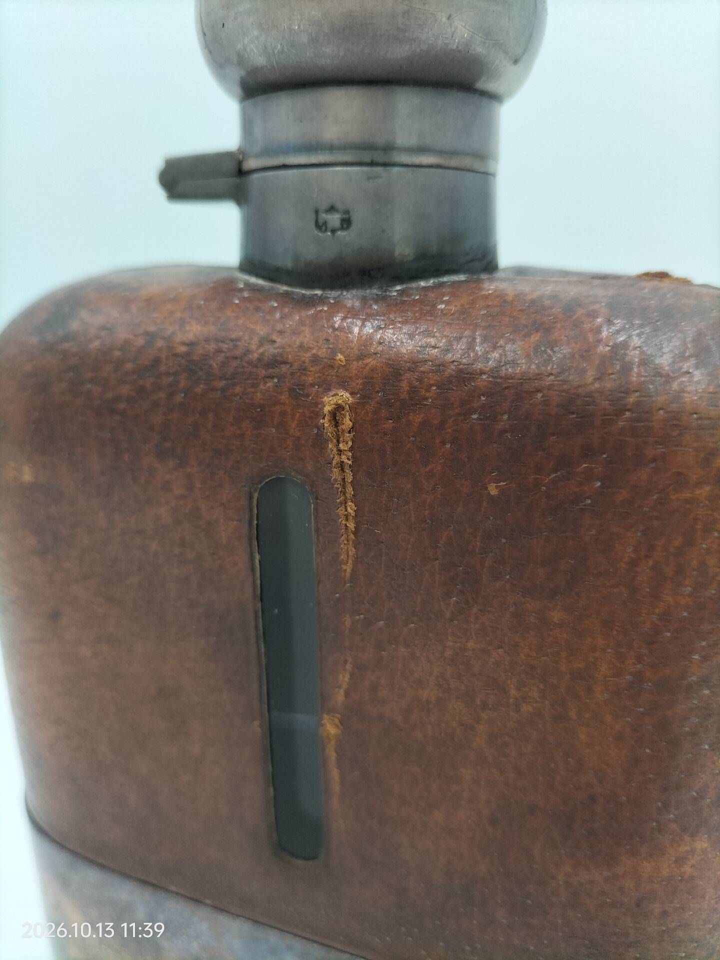 Silver-plated metal flask with leather and glass