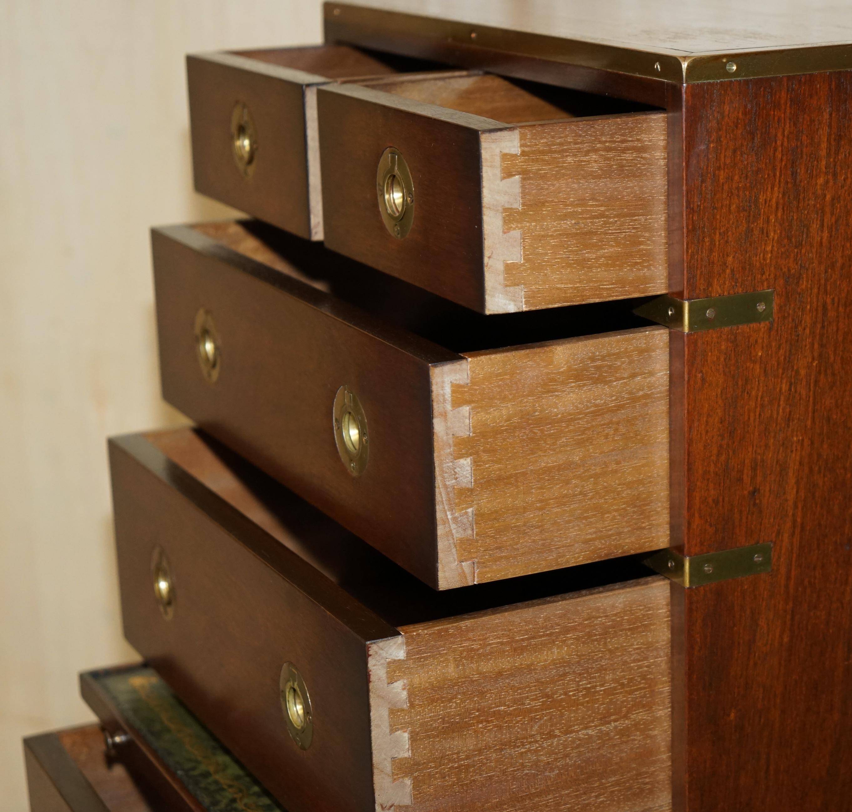 Pair of vintage military campaign high chests of drawers with leather tops.
