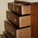 Pair of vintage military campaign high chests of drawers with leather tops.