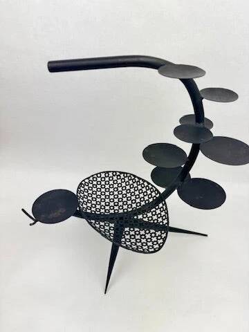 Candlestick sculpture in perforated iron clover motif