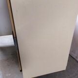 Old fridge behind wooden bar