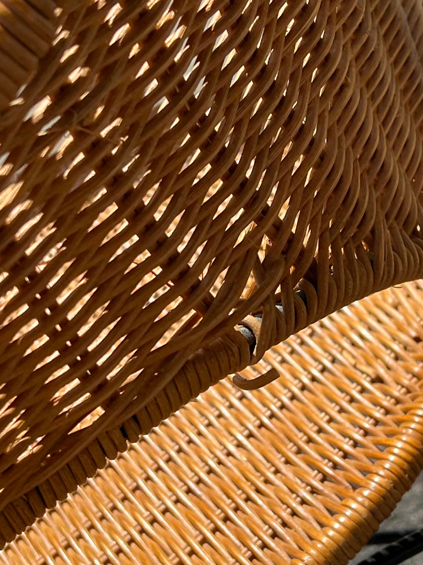 Wicker and black wrought iron armchair