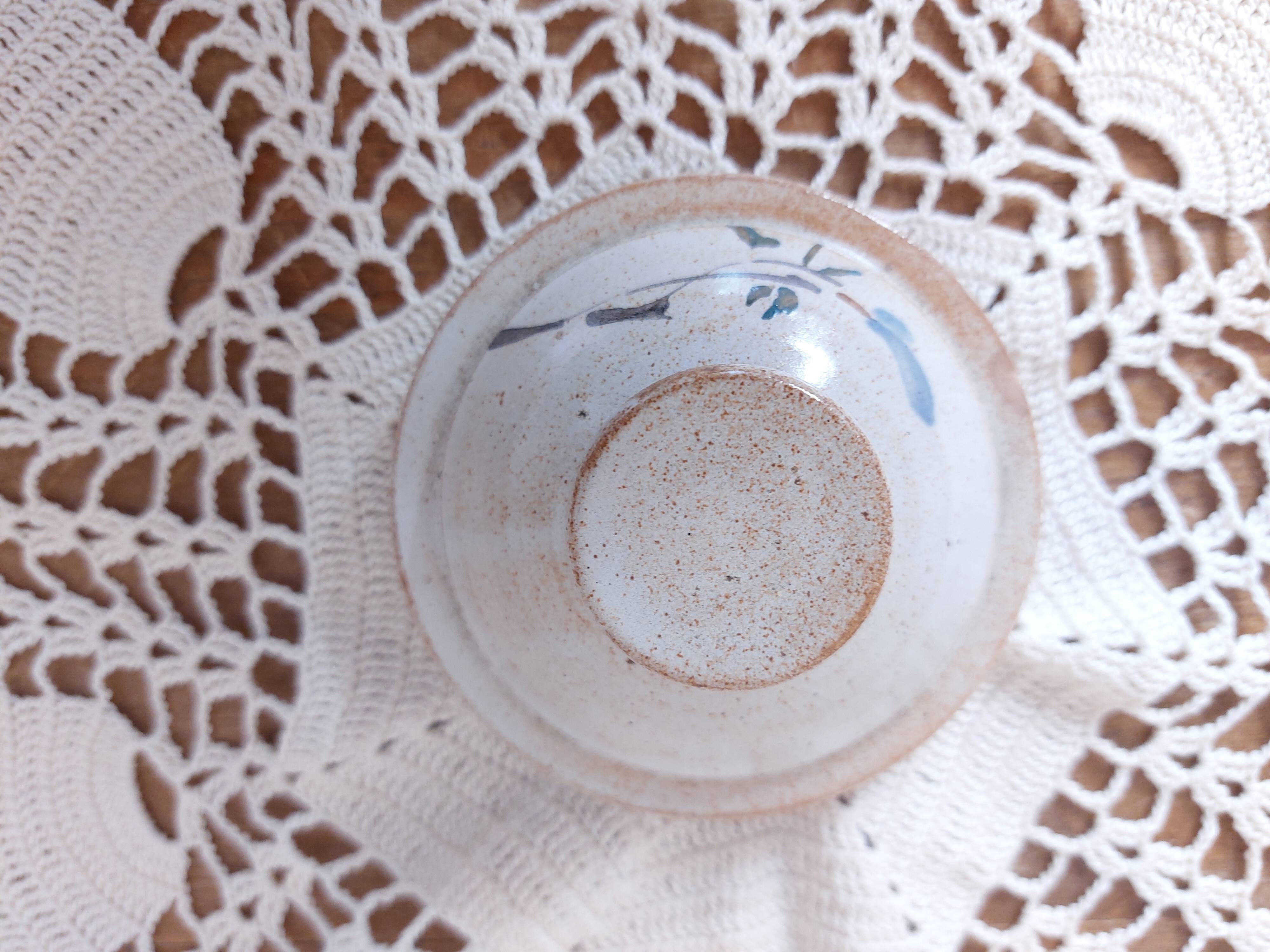 Old large vintage stoneware olive pot with its wooden spoon