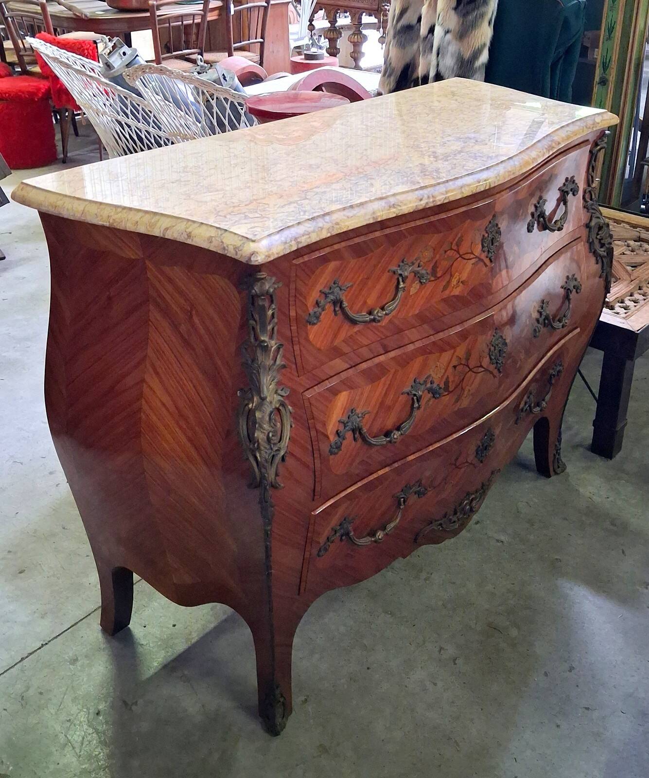 Curved Louis XV style commode with marquetry, opening with three drawers.
