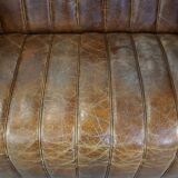 Cognac-colored cowhide 2-seater designer sofa finished with piping