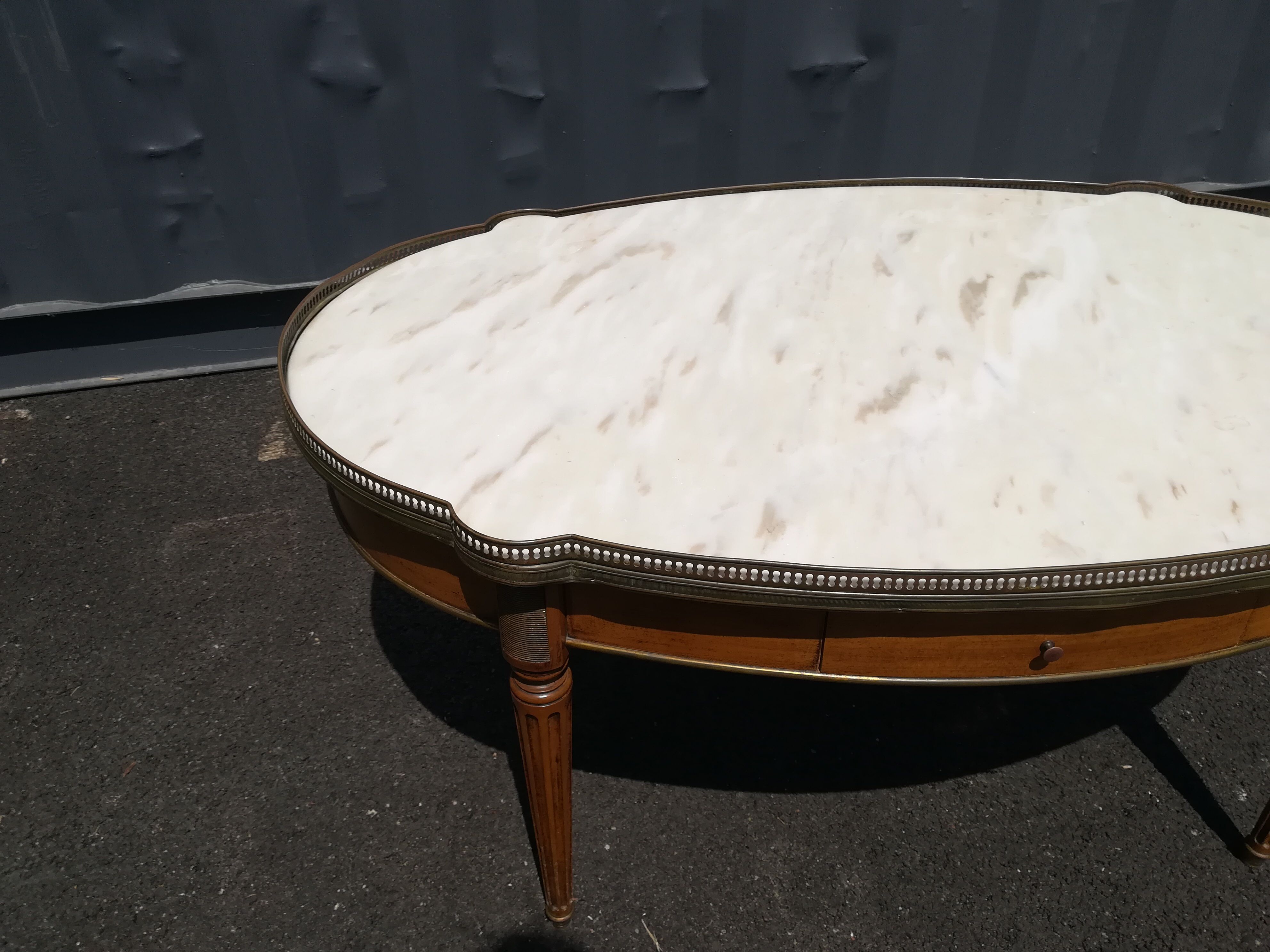 Oval marble and wood coffee table