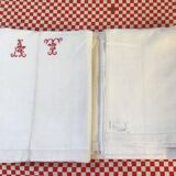 Sheet marked AT in red cross stitch