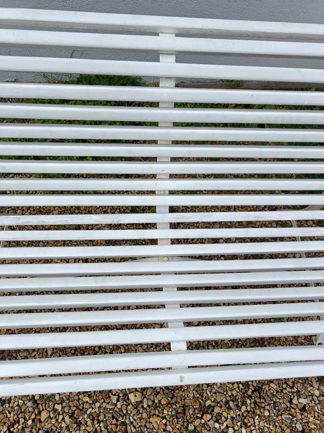 Old garden bench with metal legs and wooden slats