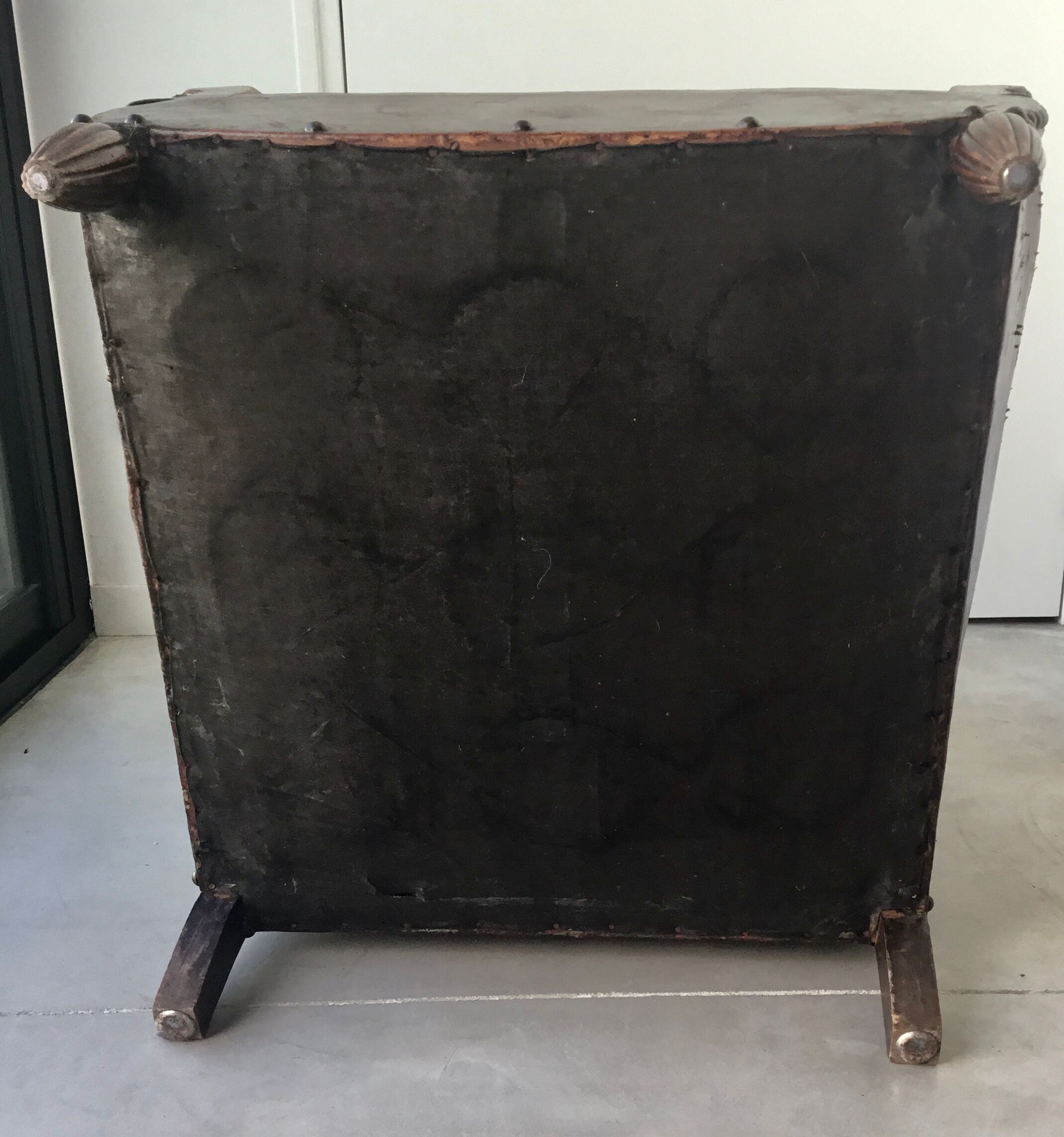 Club armchair in studded leather - early twentieth century