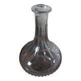 Round-bellied glass carafe with ribbed neck.