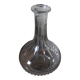 Round-bellied glass carafe with ribbed neck.