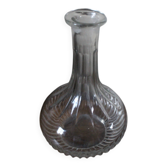 Round-bellied glass carafe with ribbed neck.