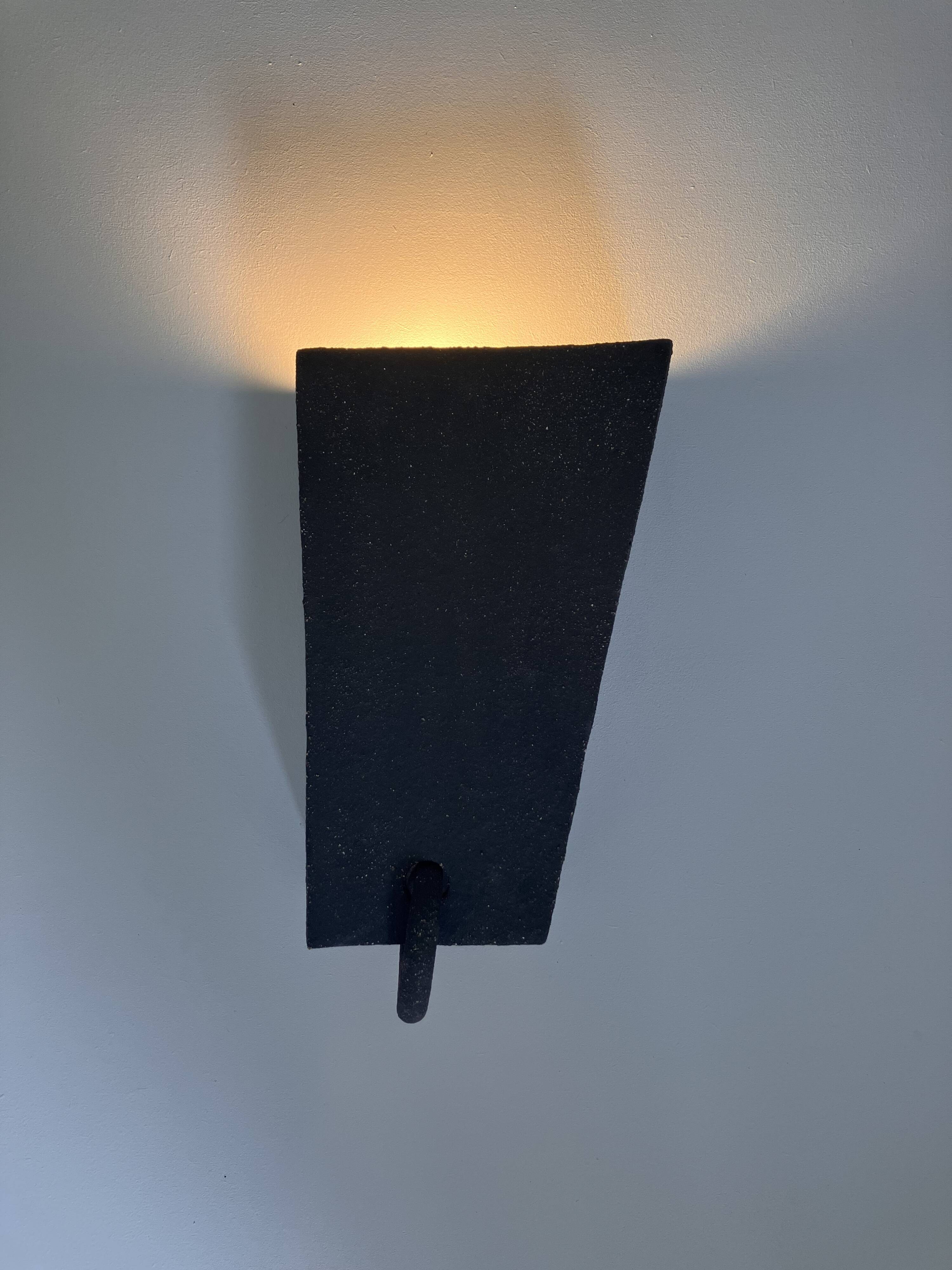 Pair of black stoneware graphic wall lights with handmade ring.