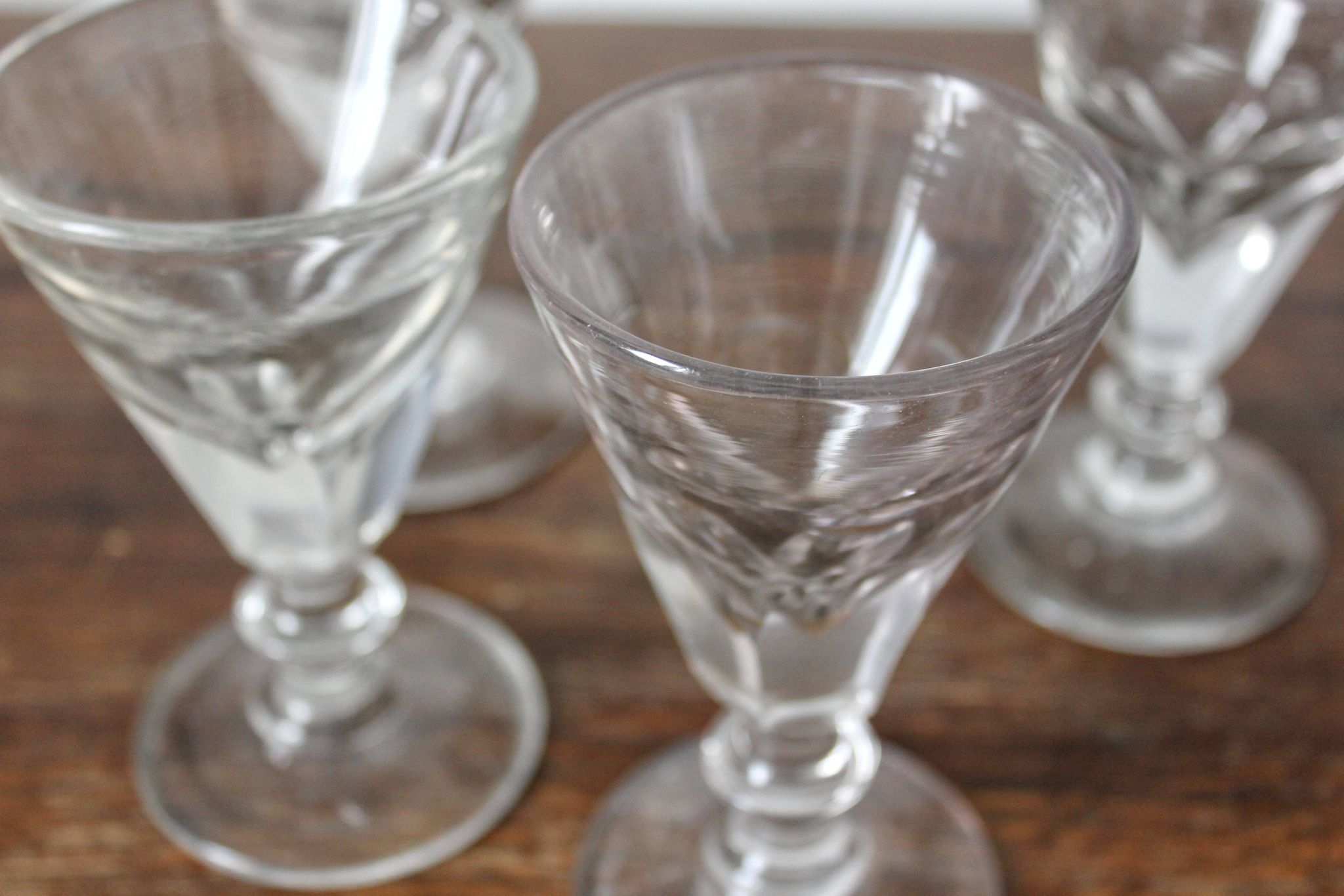 4 antique stemmed wine glasses with flat sides, made of blown glass from the 19th century