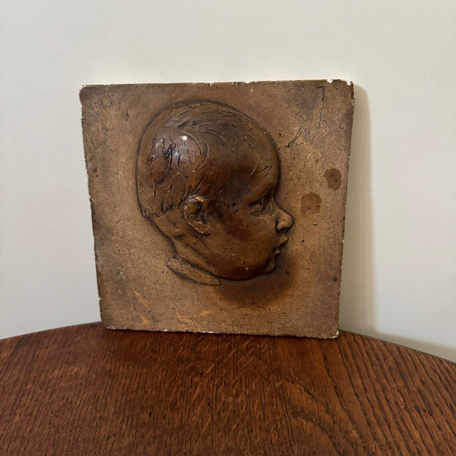 Workshop plaster medallion by Ch. Filleul, head of a young child, 20th century