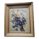 Old oil painting depicting a bouquet of flowers.