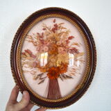 Medallion of dried flowers with a domed frame