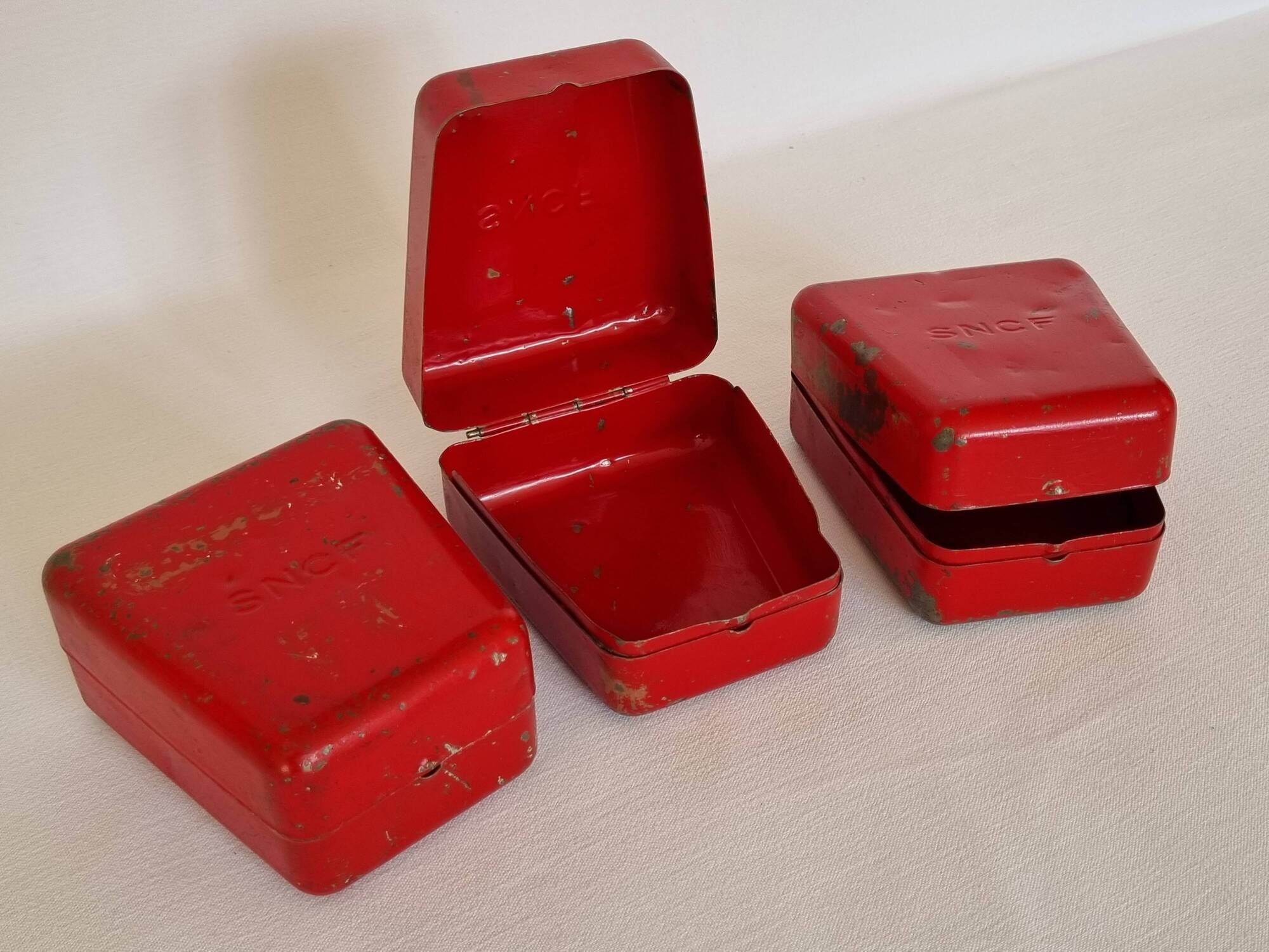 Set of three red painted metal railway boxes with SNCF logo