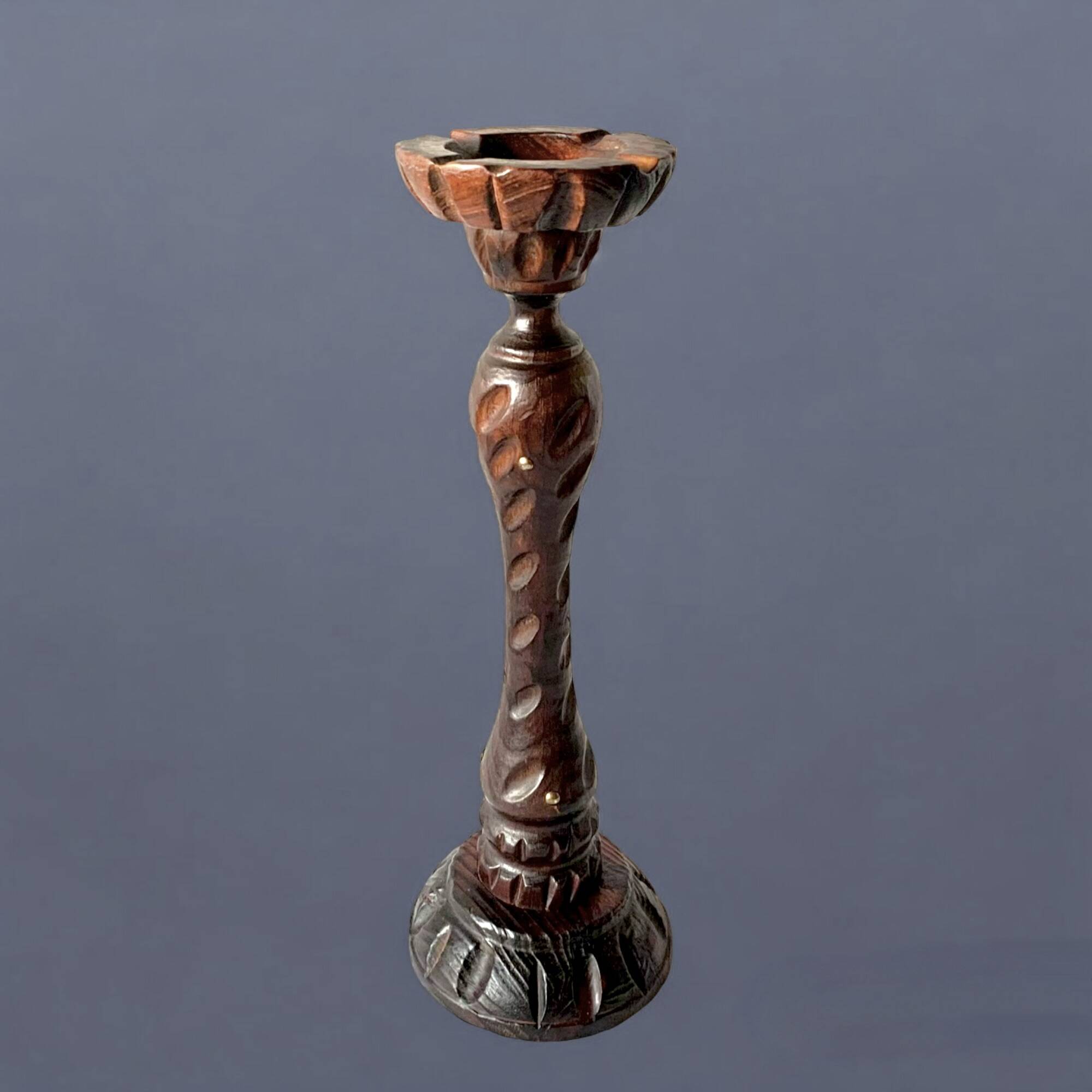 Old ashtray on carved wooden stand