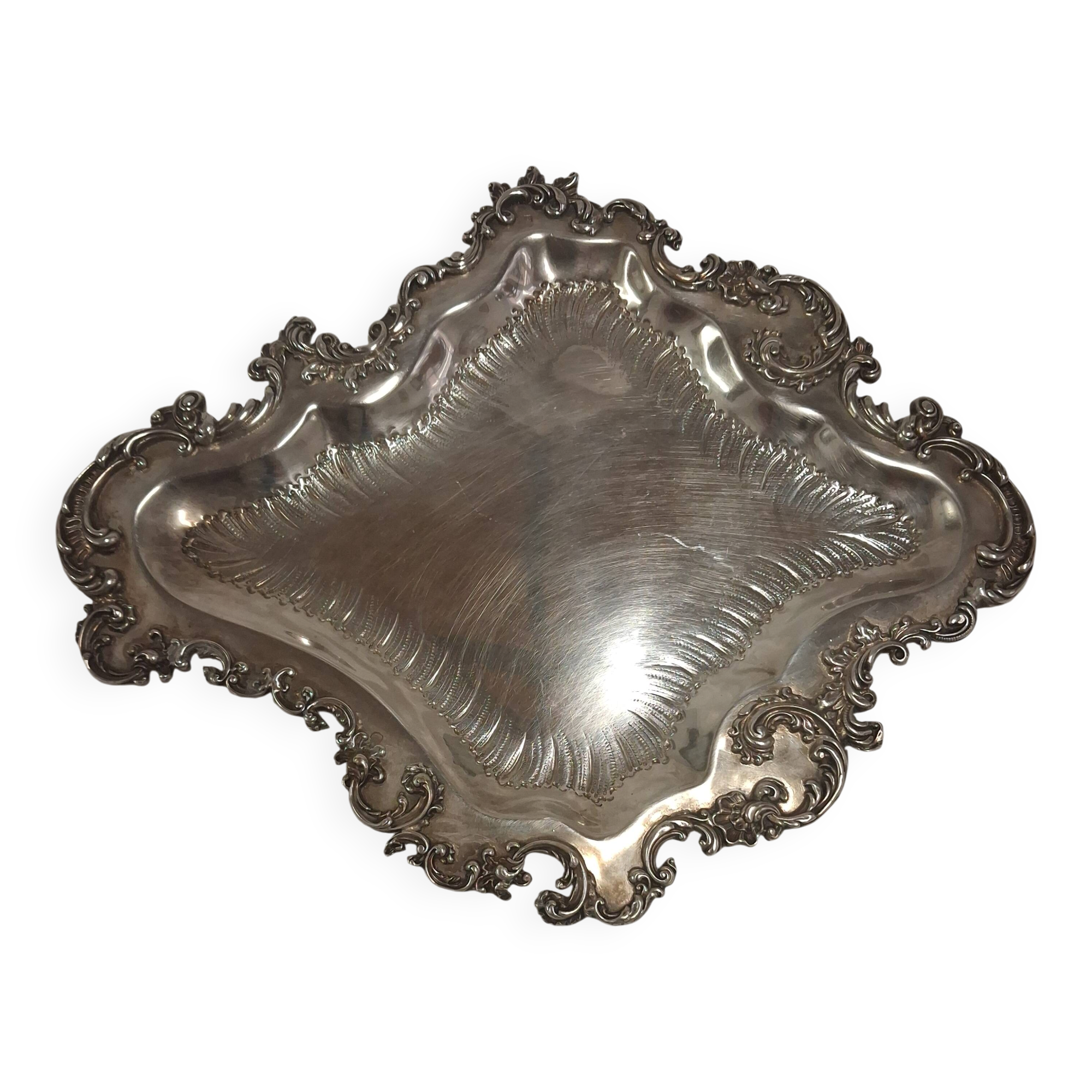 Old small silver-plated tray with a design of scrolls and leaves.