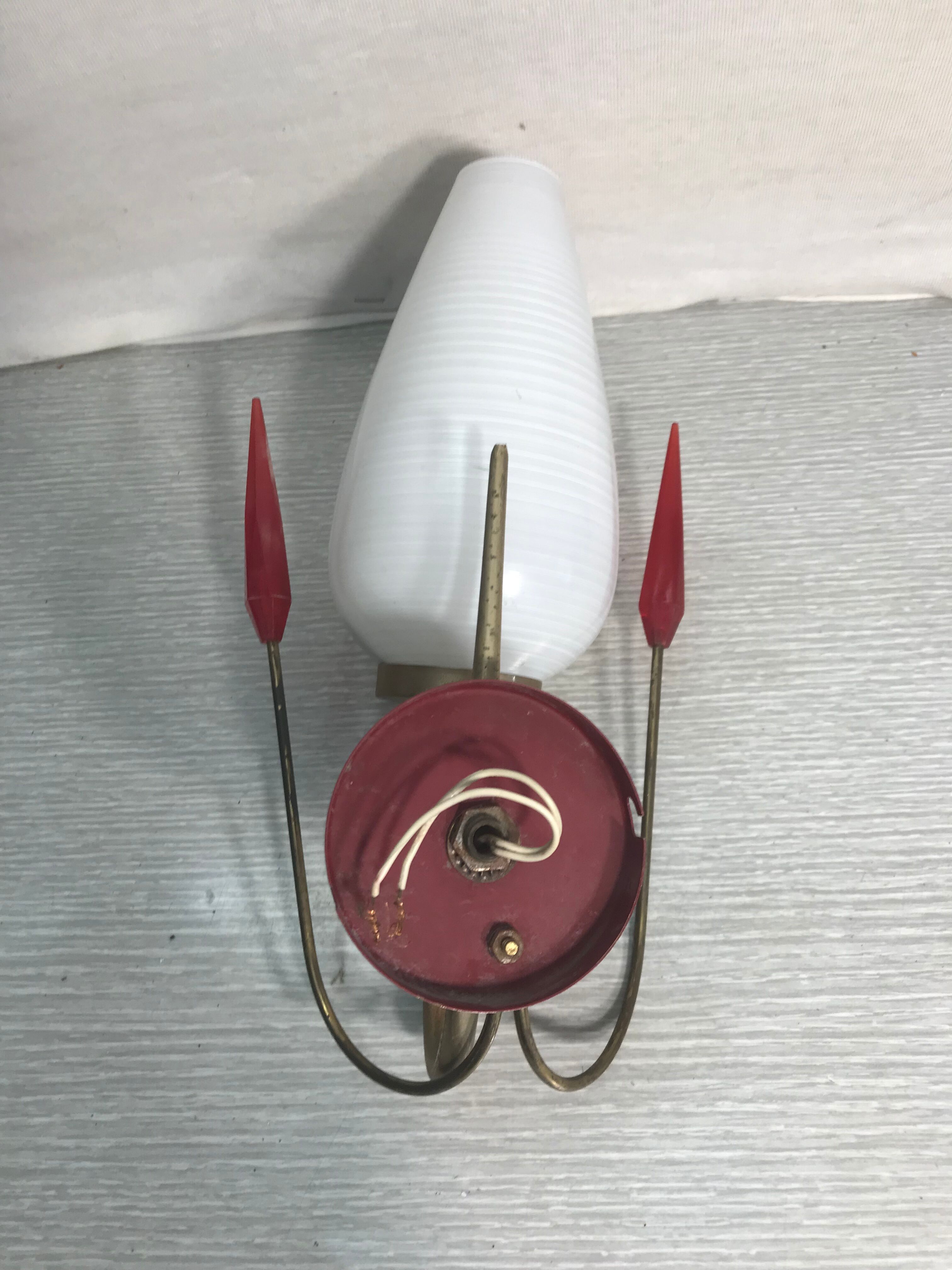 Golden metal wall sconce with red and white opaline reflectors