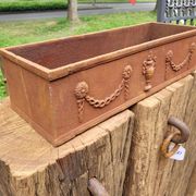 Rusty cast iron jardiniere planter