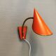 Danish red lacquered wall light with brass details. Estimated 1980s
