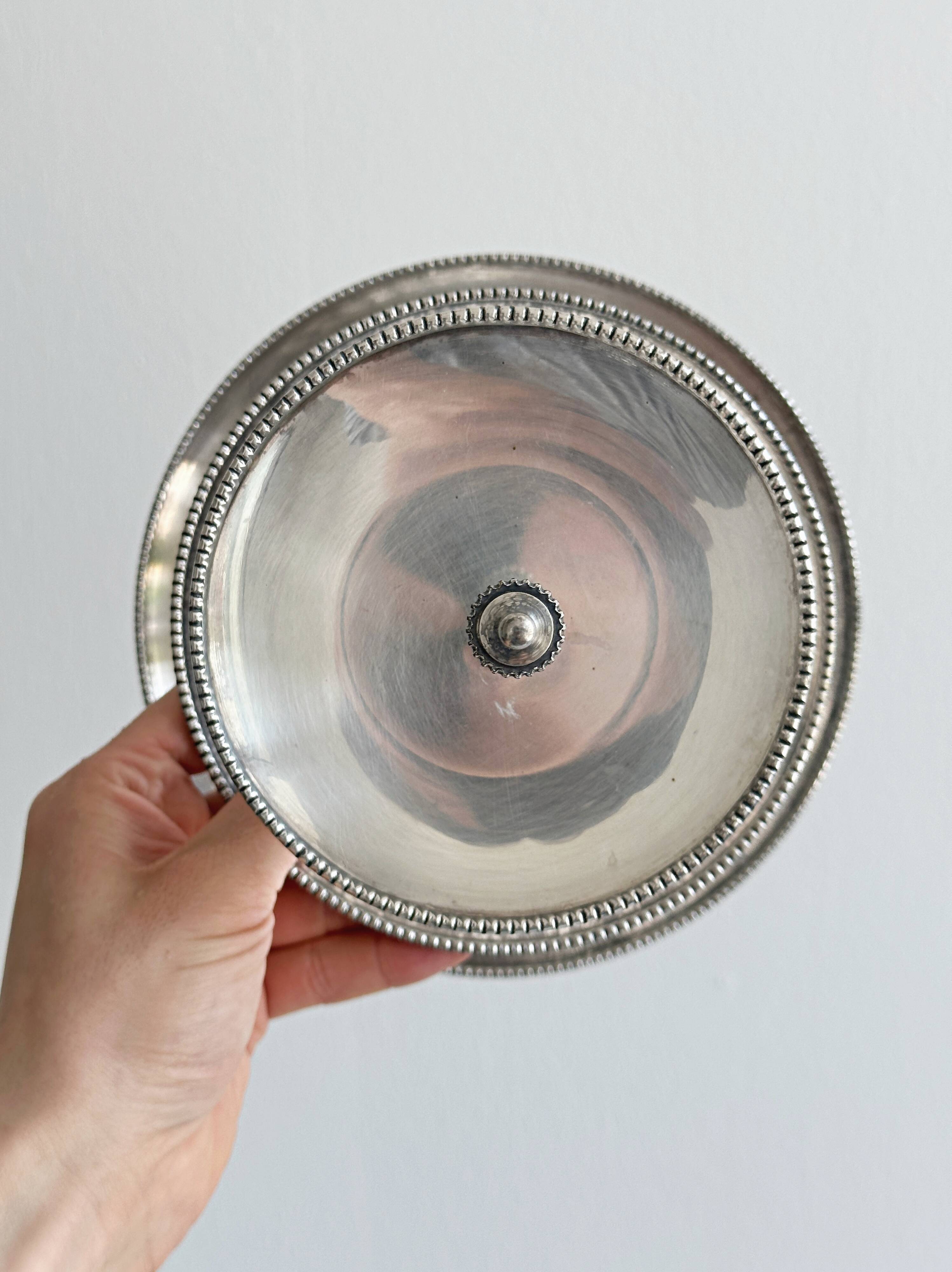Vintage three-tiered serving stand in patinated silver metal.