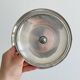 Vintage three-tiered serving stand in patinated silver metal.